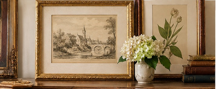 Illustrative antique-style framed landscape print and botanical artwork