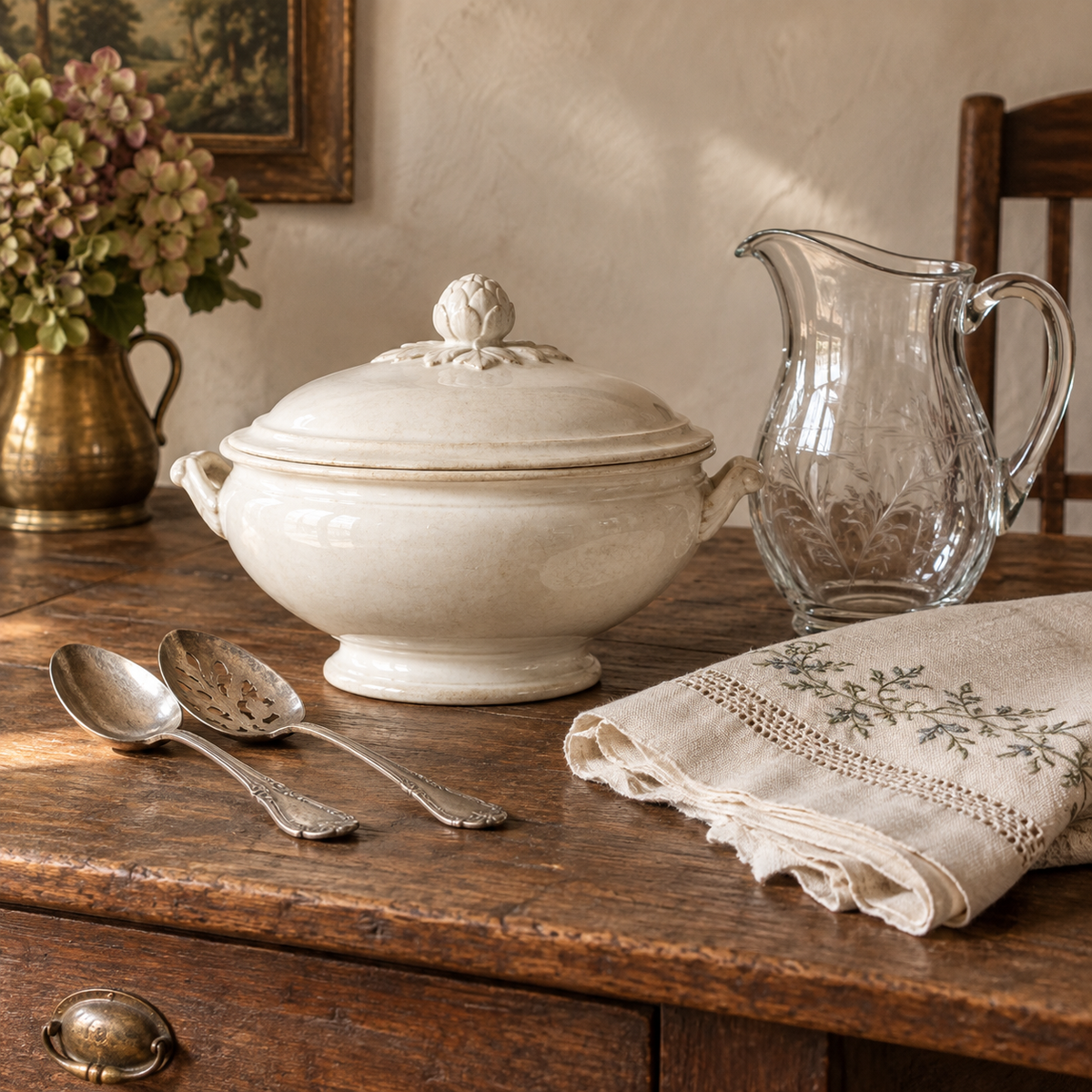 Ironstone tureen, antique glass pitcher, silver servers, and embroidered linen