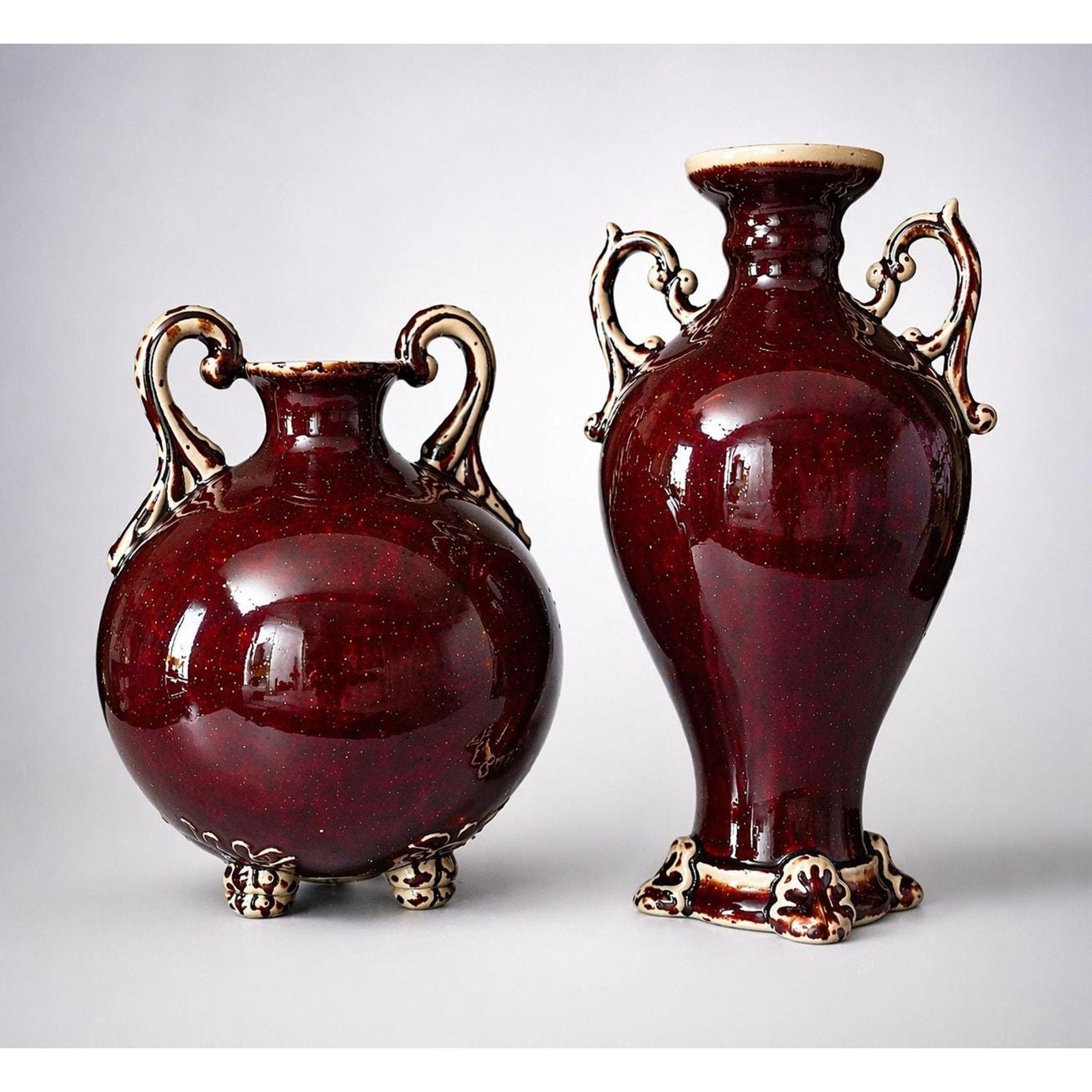 Oxblood Flambé Urn Pair: Hollywood Regency Red Ceramic Vases, Rococo Handles